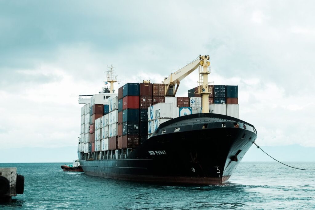 A large cargo ship loaded with shipping containers docked at Davao harbor, Philippines.